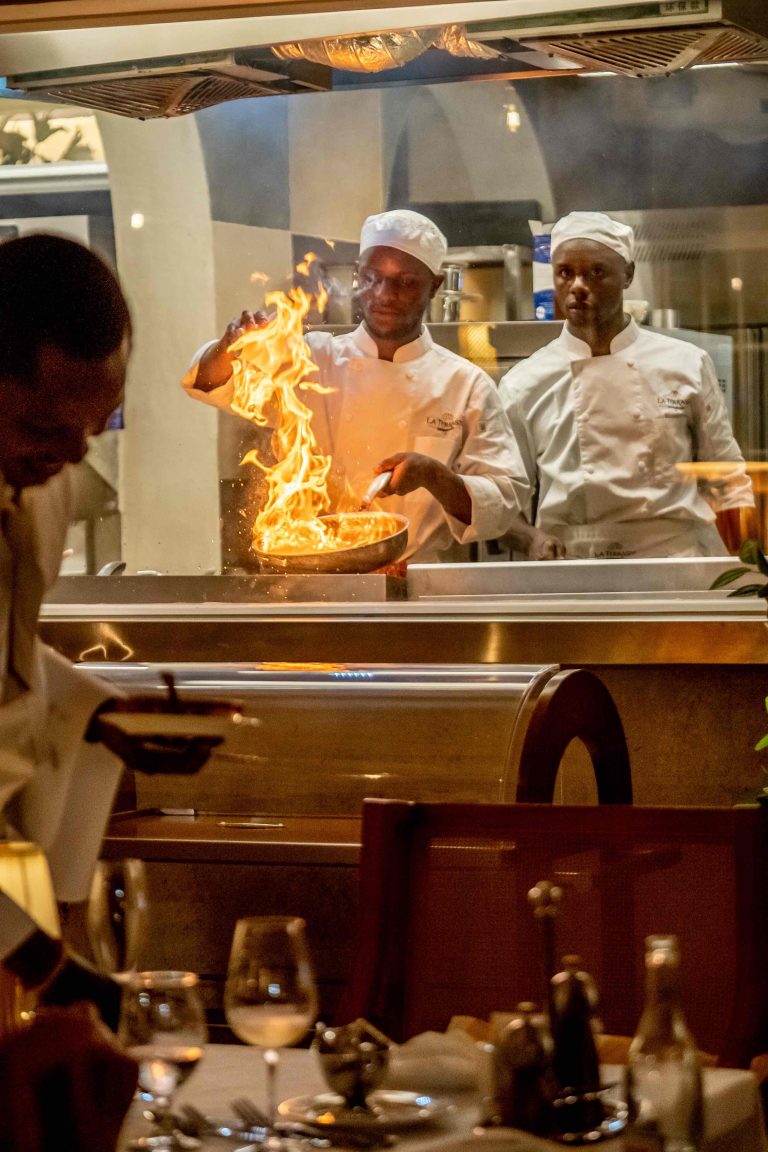 Talented chef flame-cooking signature French-inspired dishes at La Terrasse Diani